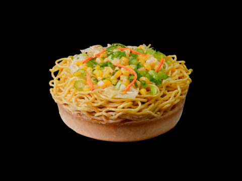 Frozen Vegan Miso Ramen from ramen RAIJIN topped with fresh vegetables on a black background.