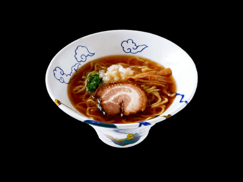 Ramen RAIJIN's Umami Shoyu Frozen Ramen with pork belly cha-shu in a soy broth, served in a decorative bowl.