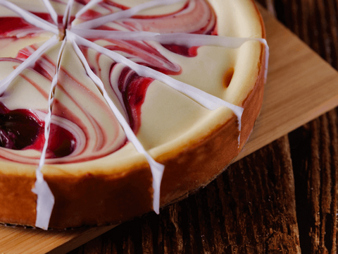 Strawberry Swirl Cheesecake with rich strawberries and creamy texture on a wooden board, perfect dessert for any occasion.